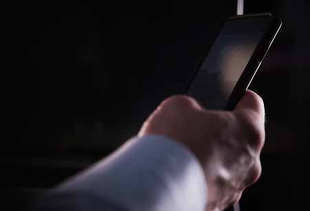 Caucasian Businessman Hand with Smartphone Closeup Photo. Internet, Cellphone Carrier and Mobile Wireless Technologies Theme.の写真素材