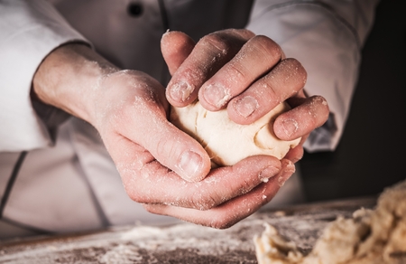 Bread Rolls Making Closeup Photo. Caucasian Baker at Work.の写真素材