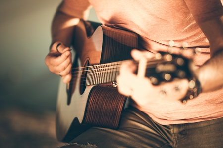 Caucasian Guitarist Playing Acoustic Guitar. Closeup Music String Instrument Theme.の写真素材