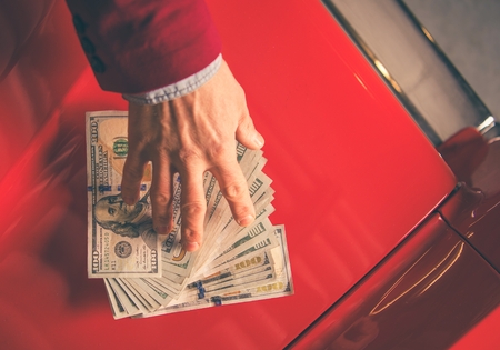 Paying For the Car. Caucasian Men Giving Thousand Dollars For the Aged Classic Car.の写真素材