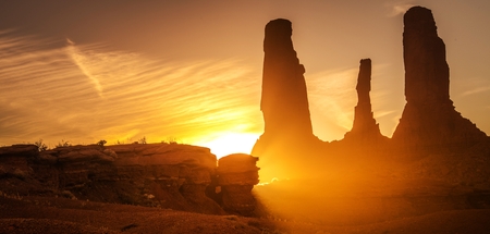 Raw Arizona Sunset. Scenic Sunlight in the Monuments Valley, United States. Rocky Sandstone Formations. Panoramic Photo.の写真素材