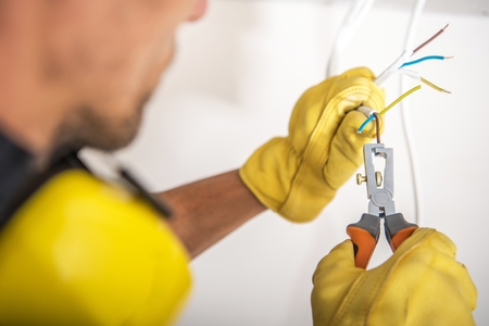 Building Proper Electrical System. Electric Technician Preparing Cables For the Outlet Installation.の写真素材