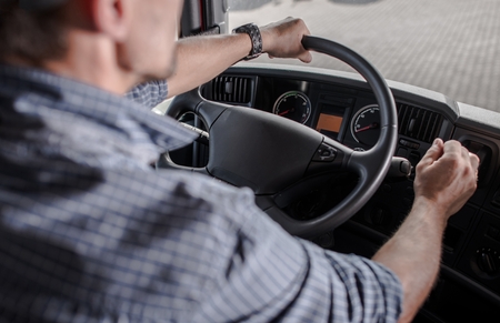 Transportation Industry Commercial Vehicle Driver. Caucasian Trucker Behind the Wheel.