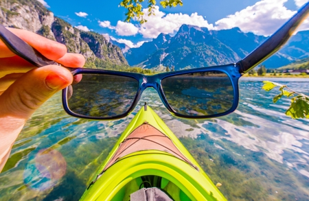 Kayaking in the Sun. Kayaker is About to Wear His Sunglasses Before Kayak Trip on the Scenic Lake.の写真素材