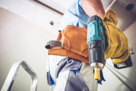 Construction Contractor Job. Caucasian Men with Power Tool Preparing For His Work.の写真素材