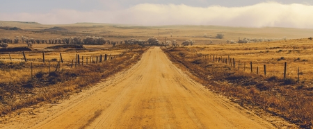 Foggy Countryside Gravel Road in Central Colorado, United States of America. Panoramic Photo.