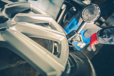 Vulcanizing Tires Service. Tire Removing From the Alloy Wheel. Professional Machine Operating.の写真素材