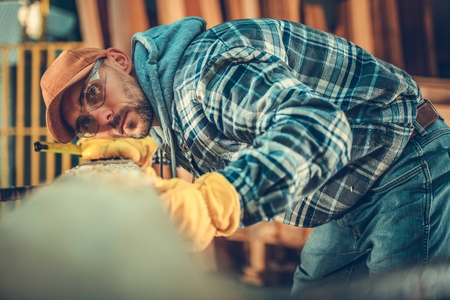 The Woodwork Passion. Caucasian Men and the Beam. Building Using Wood Material.の写真素材