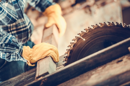 Woodworking Theme. Carpenter Wood Cut Job. Circular Saw in Action.
