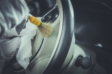 Detailed Car Steering Wheel Cleaning. Professional Vehicle Cleaning Service Concept.
