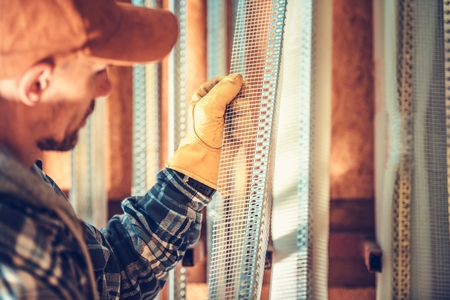 Corner Beads. Drywall Building Materials Choosing by Caucasian Contractor Worker.