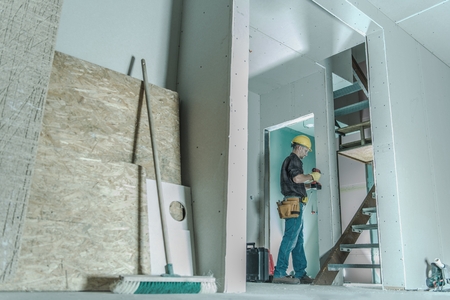 Caucasian Construction Contractor in His 30s Finishing Home Interior. Building Drywalls.