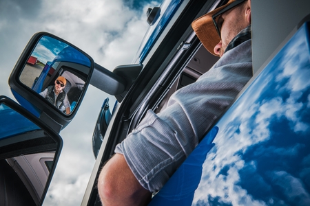 Caucasian Truck Driver on the Road to Destination. Transportation Industry.の写真素材