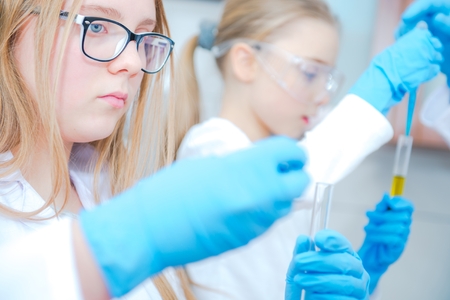 Chemistry Learn by Kids. Two Caucasian Girls with Laboratory Equipment.の写真素材