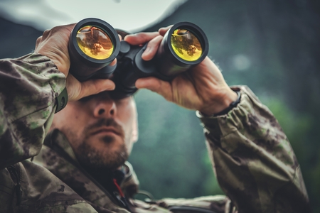 Caucasian Army Soldier in His 30s with Binoculars in Hands. Military Theme.の写真素材