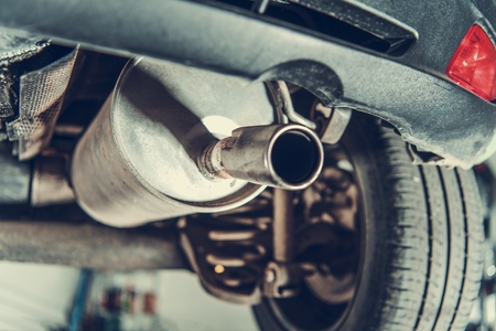 Car Emission Test Theme. Modern Compact Car Muffler Closeup.の写真素材