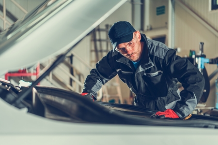 Caucasian Car Mechanic Solving Vehicle Engine Problems. Automotive Industry Theme..の写真素材