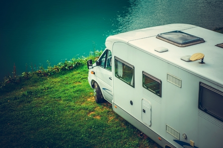Waterfront Recreational Vehicle Camping. Camper Van on the Edge of Glacial Lake.の写真素材