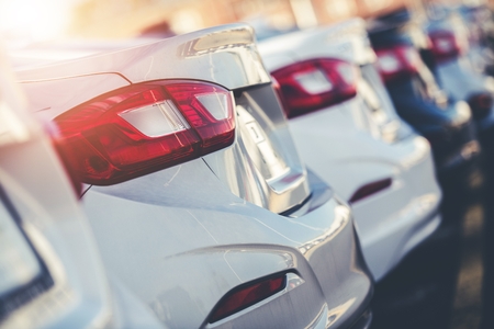 Car Factory Outlet. Row of Brand New Vehicles Ready to Dealership Distribution.の写真素材