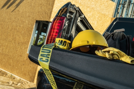 Hard Hat and Caution Tape on the Pickup Truck. Construction Zone Safety. Industrial Theme.の写真素材