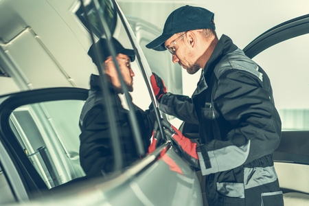 Vehicle Mechanic Job. Caucasian Auto Service Worker in his 30s During His Working Hours. Automotive...