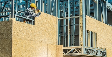 Worker and Construction Site. Skeleton Steel Frame Installation.の写真素材