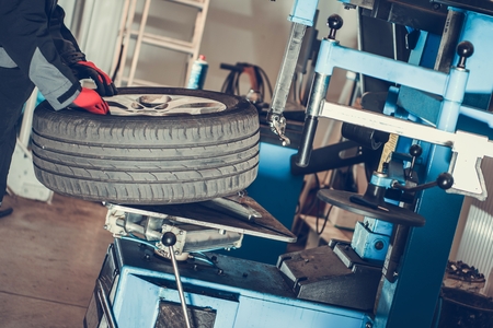 Car Wheels Maintenance. Seasonal Vehicle Tires Change. Automotive Industry.の写真素材