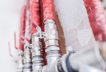 Residential Hydraulic Heating Pipelines Insulated by Red Foam. 