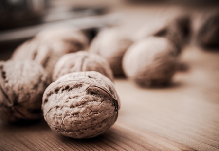 Organic Walnuts on Wood Table. Tree of the Genus Juglans Seed. Healthy Food Theme.
