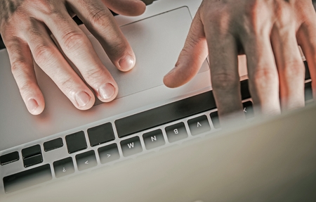 Caucasian Corporate Worker and His Work Using Laptop Computer. Top View.