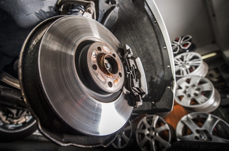Damaged Brake Disc Replacement. Modern Vehicle in the Auto Service.の写真素材