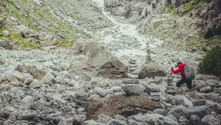 Caucasian Men on the Rocky High Mountain Trail.