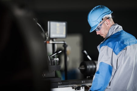 Metalworking Industrial Caucasian Worker in Hard Hat and Safety Glasses.