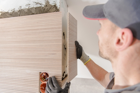 Modern Bathroom Ceramic Tiles Installation by Professional Caucasian Installer.の写真素材