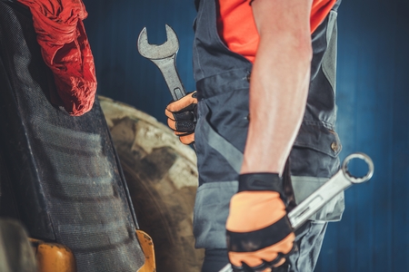 Heavy Equipment Mechanic with Large Iron Wrenches in Hands. Industrial Theme.の写真素材
