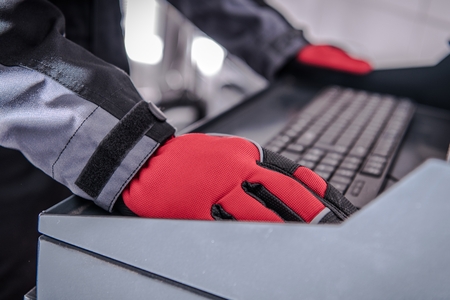 Car Diagnostic Computer. Auto Service Worker Hands on Computer Keyboard.の写真素材
