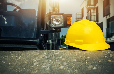 Yellow Hard Hat on the Construction Roller. Heavy Equipment Operation Safety. Industrial Theme.の写真素材