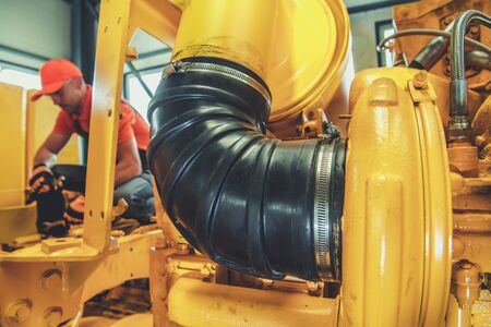 Heavy Duty Machinery Diesel Engine Repair by Professional Caucasian Technician. Industrial Theme.の写真素材