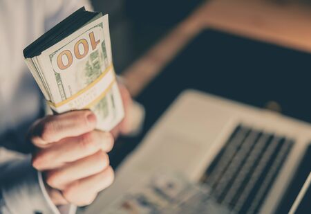 Online Casino Giveaway. Ten Thousand Dollars in Players Hand. Internet Gambling.の写真素材