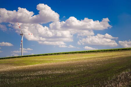Scenic Farmlands and Renewable Energy Wind Turbine Summer Time Landscape. Northern Austria, Europe.