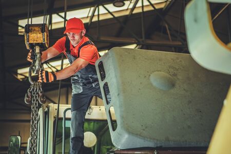 Caucasian Men in His 30s Operating Warehouse Lift. Industrial Theme.の写真素材