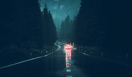 Rainy Weather Road Trip. Modern Vehicle on the Wet Mountain Route During Heavy Rainfall.の写真素材
