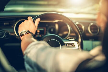 Summer Time Driving in Cabriolet. Caucasian Men on a Road Trip. Automotive and Transportation Theme.の写真素材