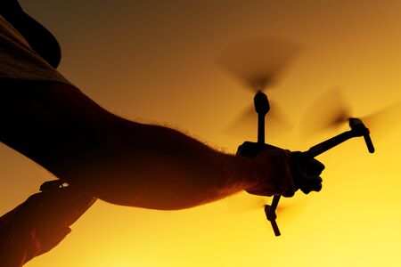 Caucasian Men in His 20s Starting His Modern Drone. Flying Remote Controlled Aircraft. の写真素材