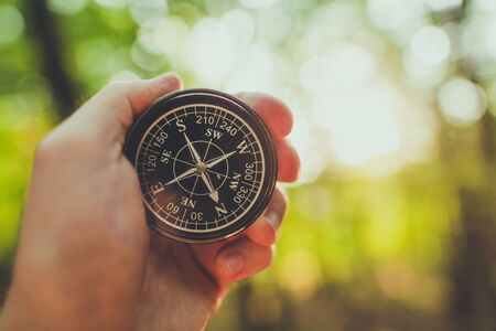 Compass in a Hand of Hiker. Useful Equipment on a Trailhead.の写真素材