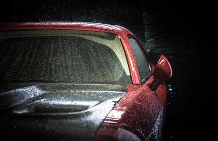 Automatic Car Wash Concept with Modern Vehicle Inside. Closeup Photo. Clean and Wet Auto Body.
