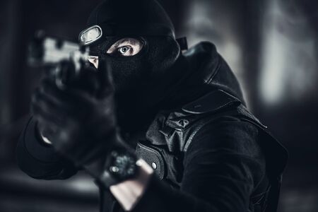 Caucasian Men in His 30s Wearing Balaclava Face Mask with Handgun. Terrorism Concept.