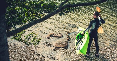 Caucasian Kayaker in His 30s Taking Scenic Lake Tour. Water Sports.の写真素材