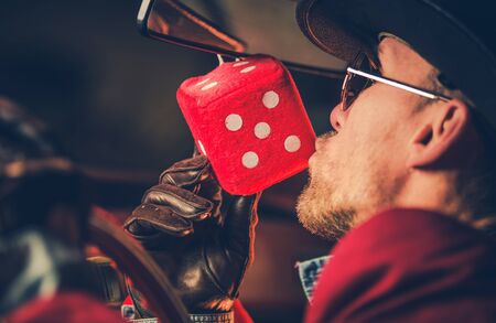 Feeling Lucky Casino Player Kissing Hanged in His Car Red Playing Dice. Gambling Theme.の写真素材