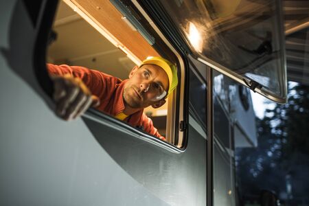 Caucasian Men in His 30s Looking Outside From His RV Camper Van Window. Motorhome Travel Theme.
